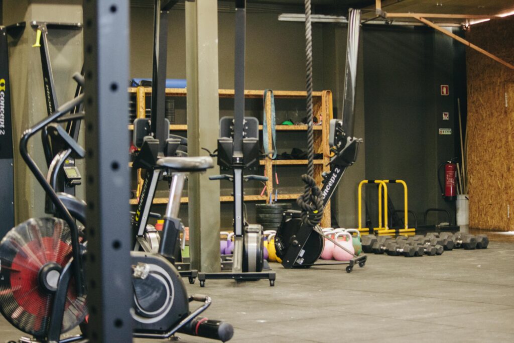 Gimnasio repleto de máquinas y materiales deportivos.