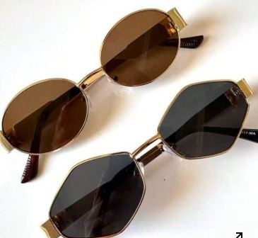 Gafas de sol marrón y negro , encima de una mesa blanca